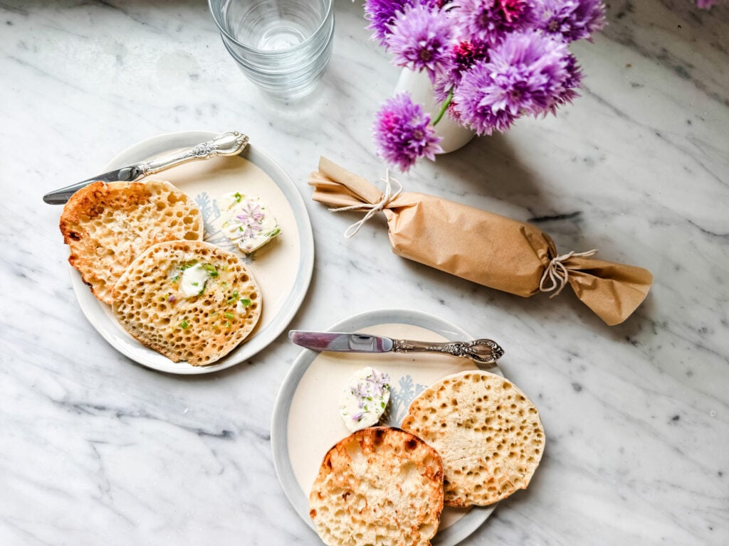 Homemade chive blossom butter on toasted English muffins.
