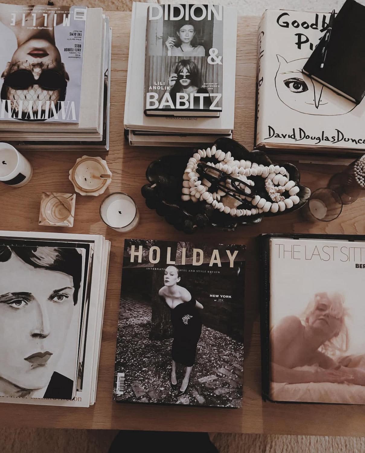 Books with faces, bowl of objects, beads,