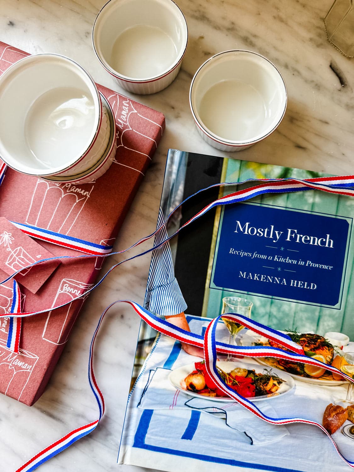 Mostly French cookbook, ribbon, ramekins.