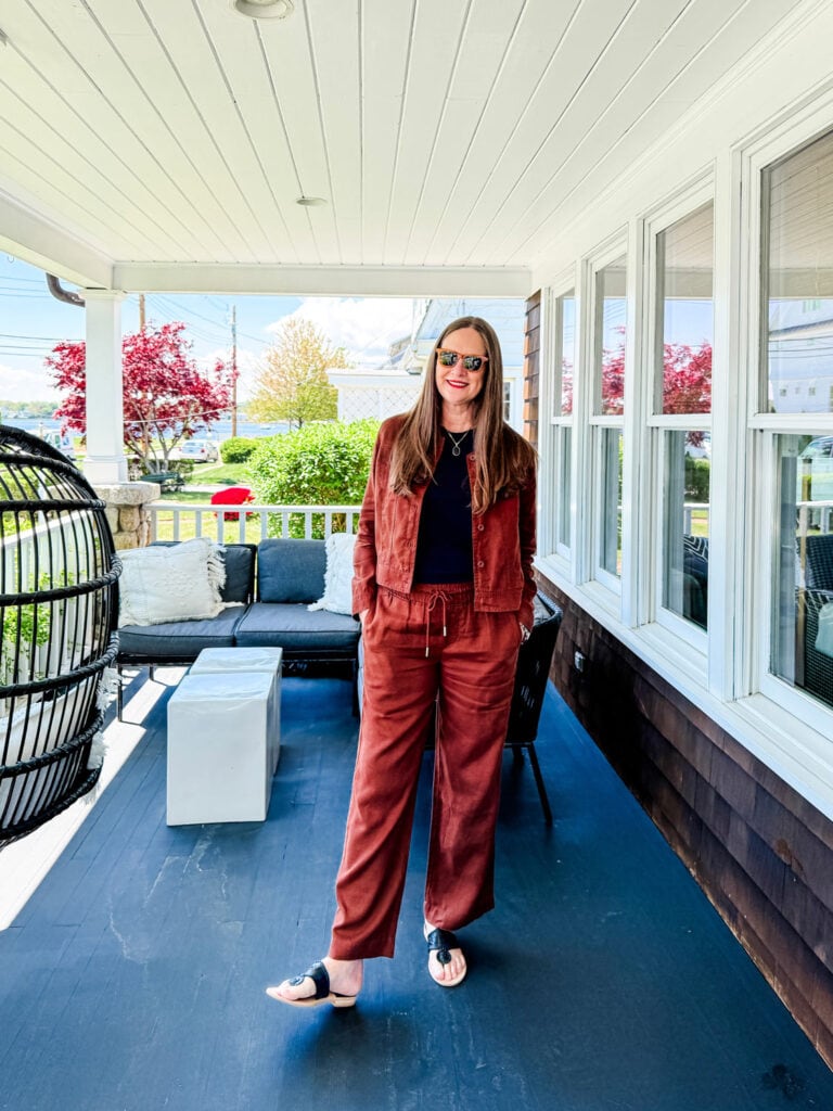 Woman wearing matched set in rust linen with black Jack Rogers sandals.