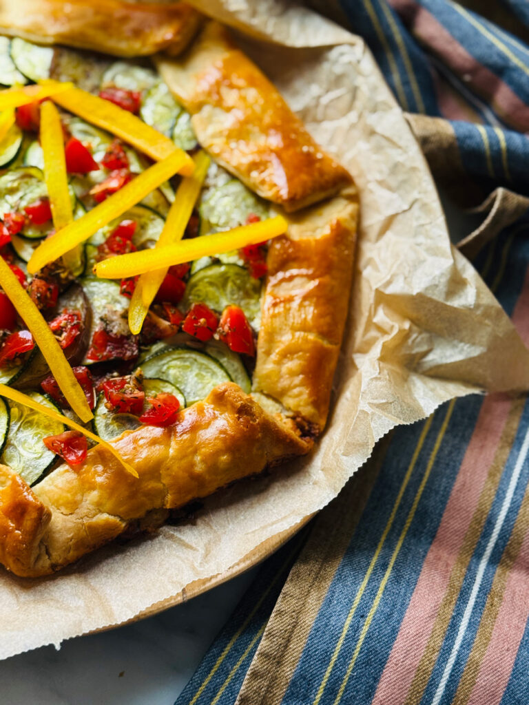 A ratatouille French galette on parchment paper fresh out of the oven.