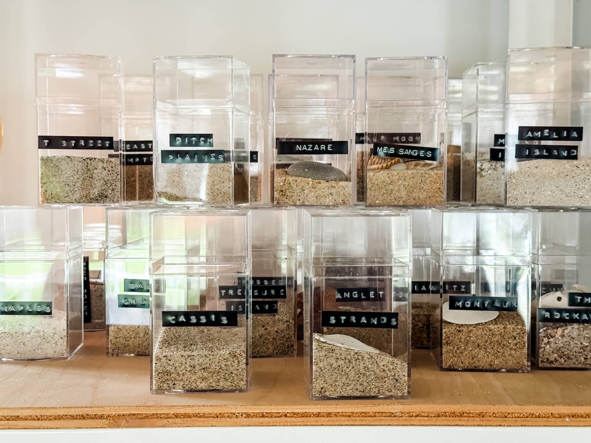 Clear boxes with sand collection and dymo label with name.