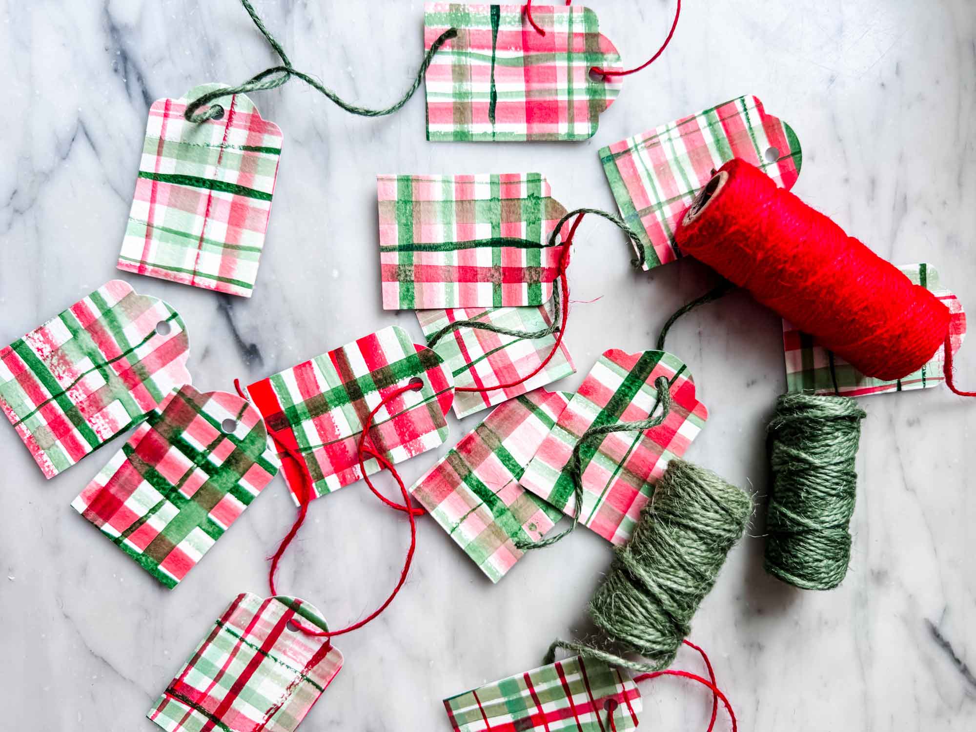 Red and green watercolor painted tags with red and green twine.
