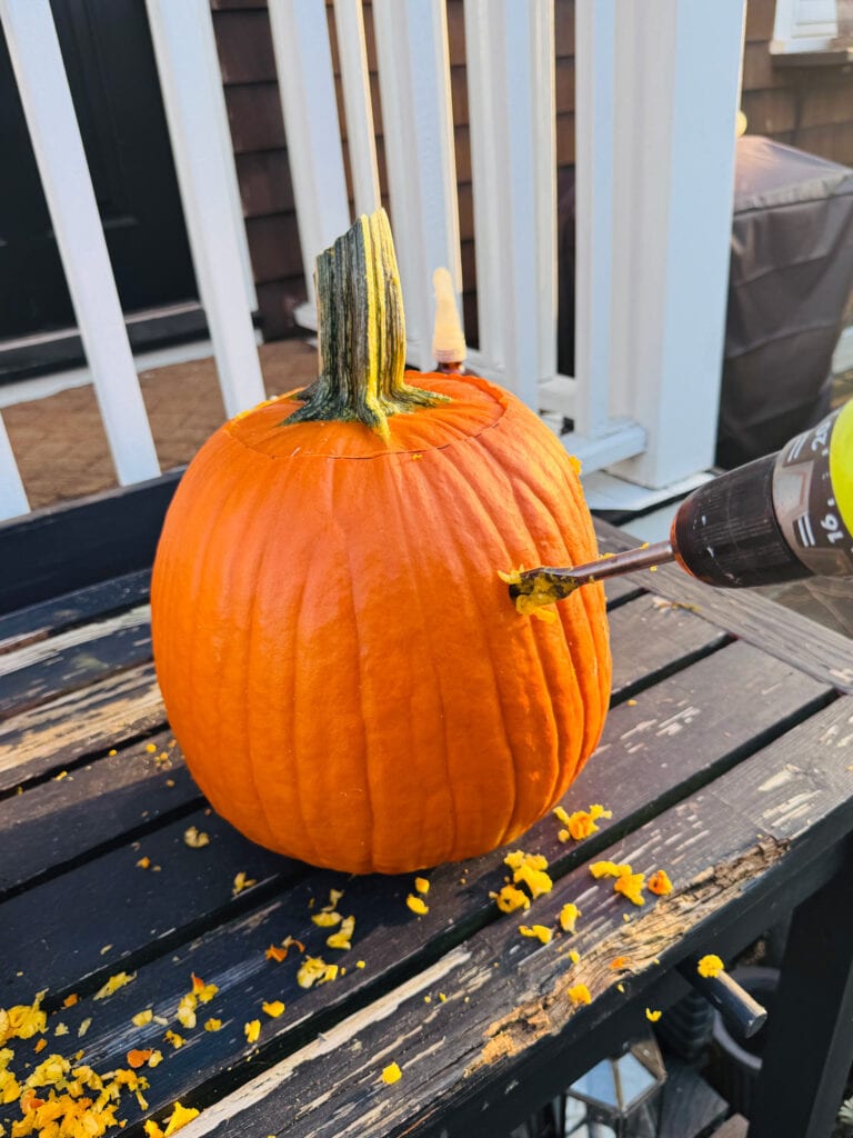 Using a drill to make polka dot pumpkins.