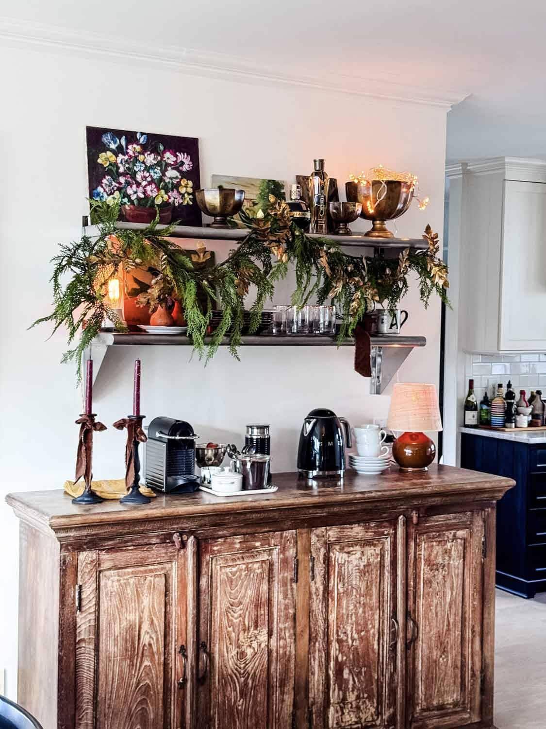Greenery is draped over the coffee bar for Thanksgiving.