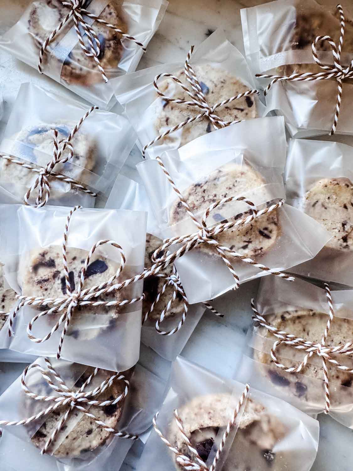 Shortbread cookies wrapped up in bags with brown and white baker's twine.