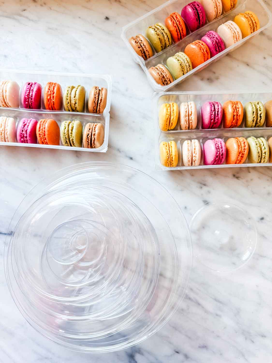 Colorful macarons on marble countertop.