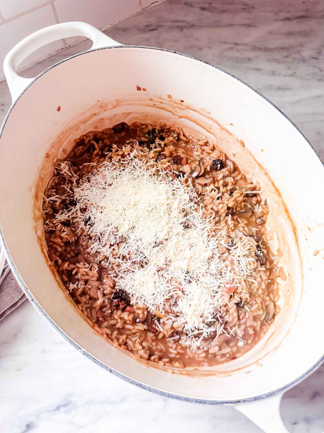 Parmesan cheese is the last ingredient added to the mushroom risotto.