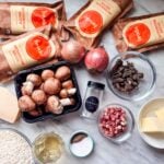 All the ingredients for making mushroom risotto are sitting on the countertop.