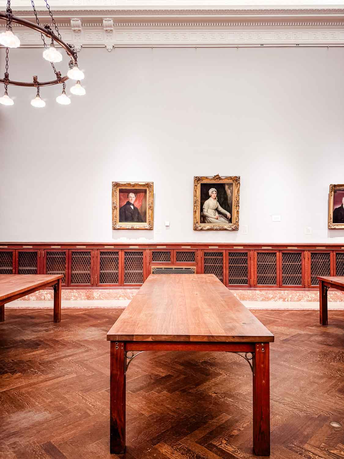 The Solomon Reading Room is sparse and lined with dark wood tables and only a few chairs scattered about the room. It's designed as a quiet space for reading, researching, or studying, and is open to the public.