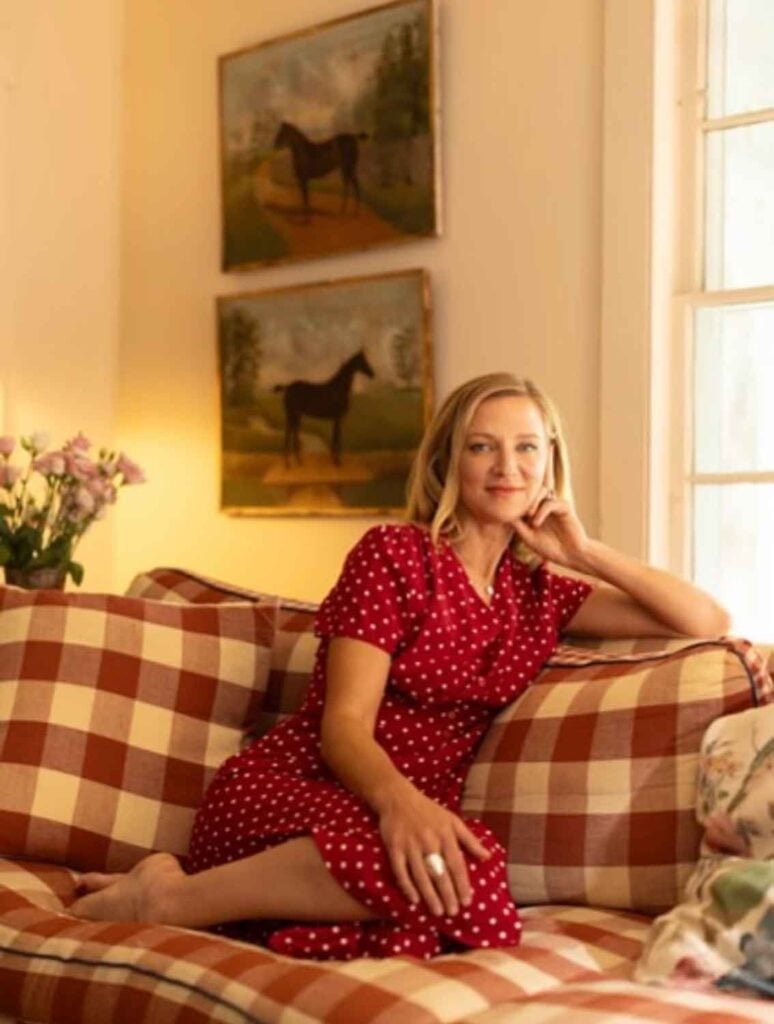 Brooklyn-based designer Christin Salway is sitting a white and red checked sofa at her home in Huson Valley, NY.