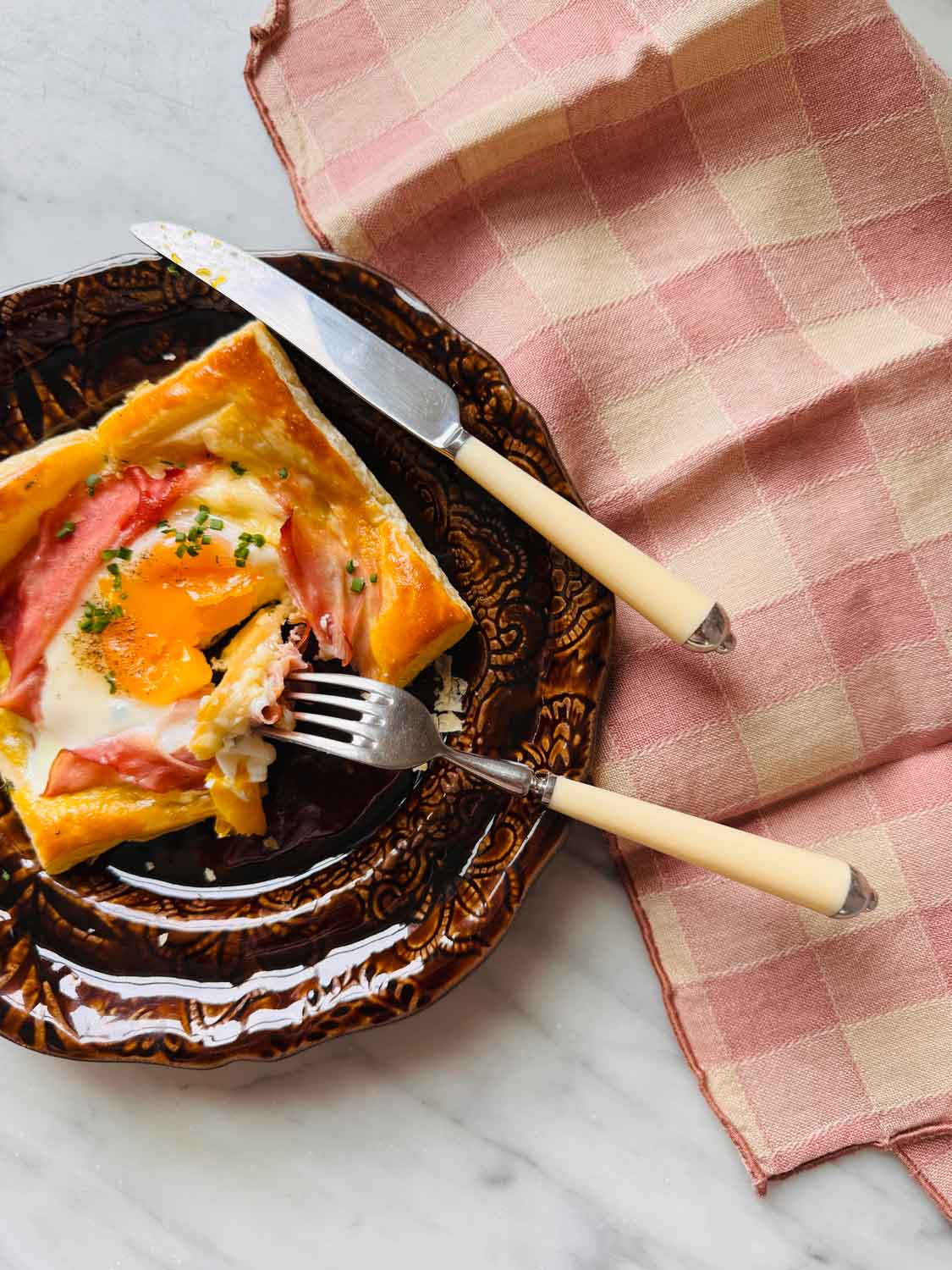 A soft yolk becomes part of the sauce in the puff pastry croque madames.