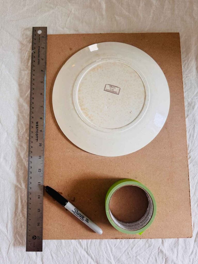 Plate on board, tape, ruler, sharpie pen.