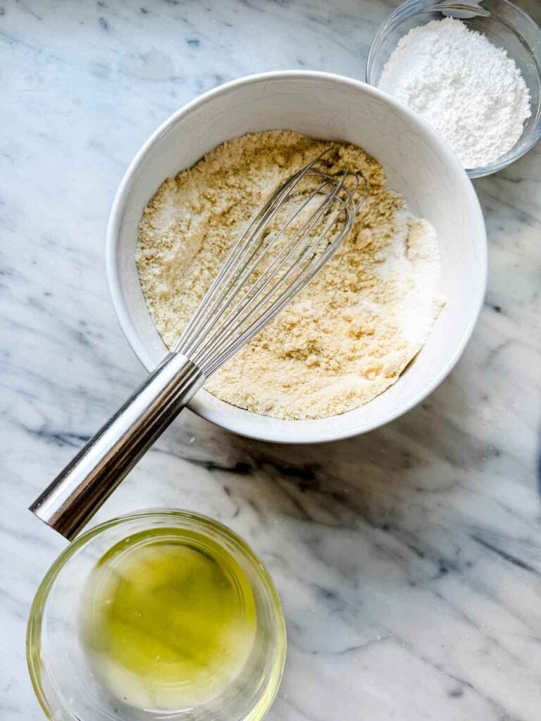 The first step in making Saint-Émilion macarons is mixing the almond flour and granulated sugar. 