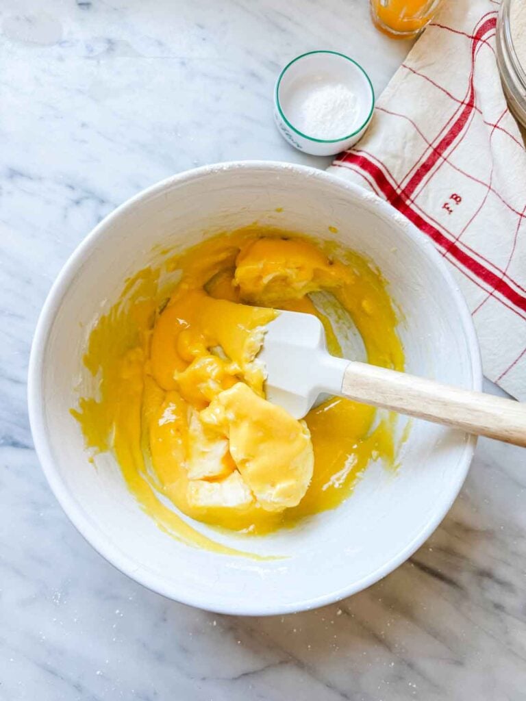 Very soft butter is added to the egg yolk and powdered sugar mixture.