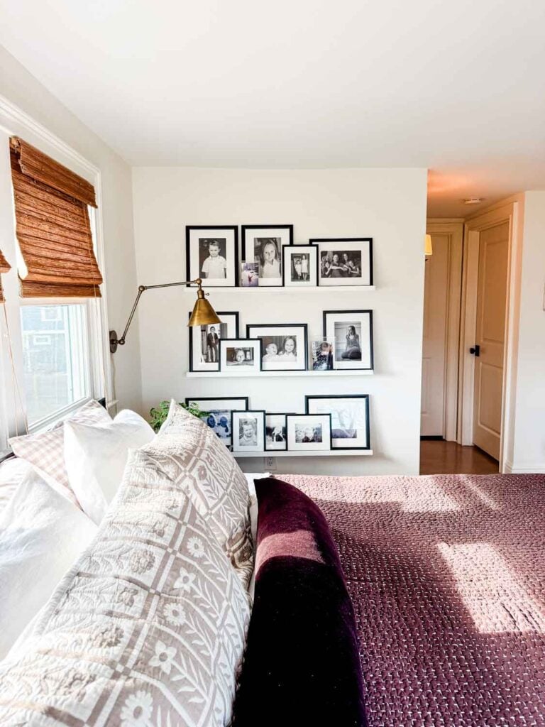 Bed with brown quilt, photo ledges with frames.