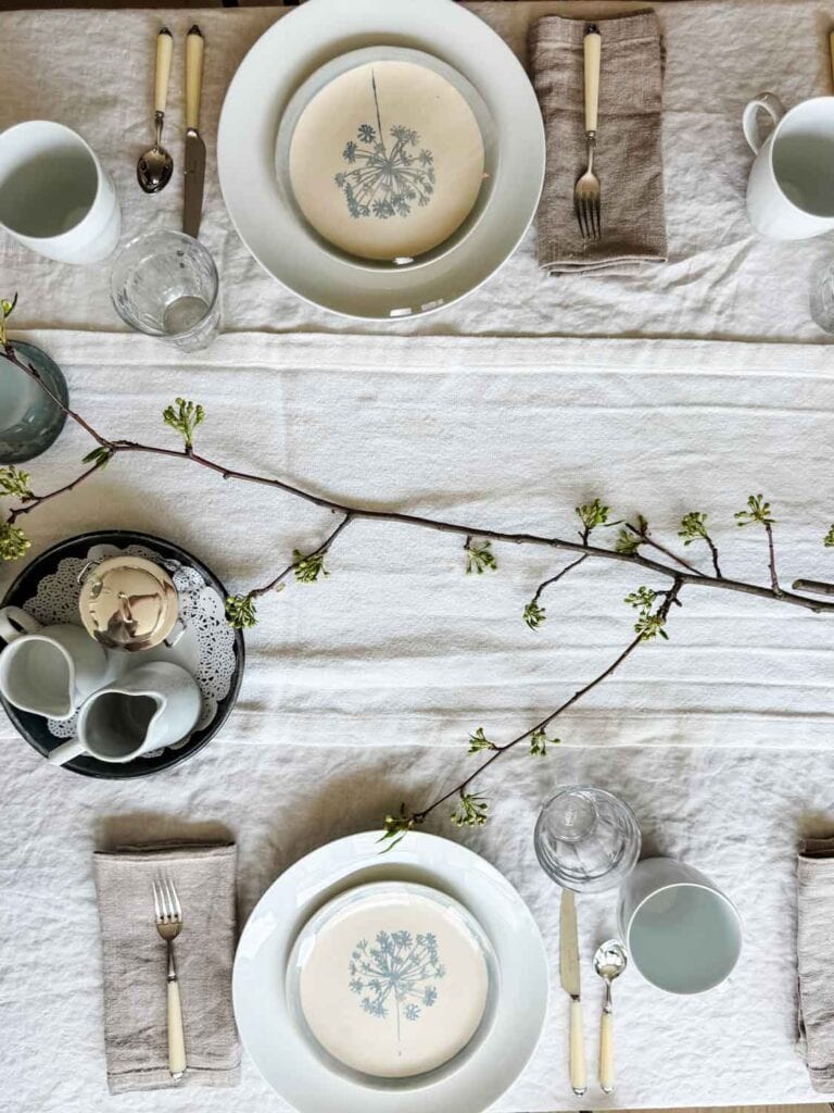 A flowering branch, clipped from our yard, is used for a table runner.