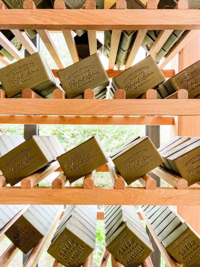Olive oil soap bars are lined up in modern wooden shelves inside the Rampal Latour flagship store.