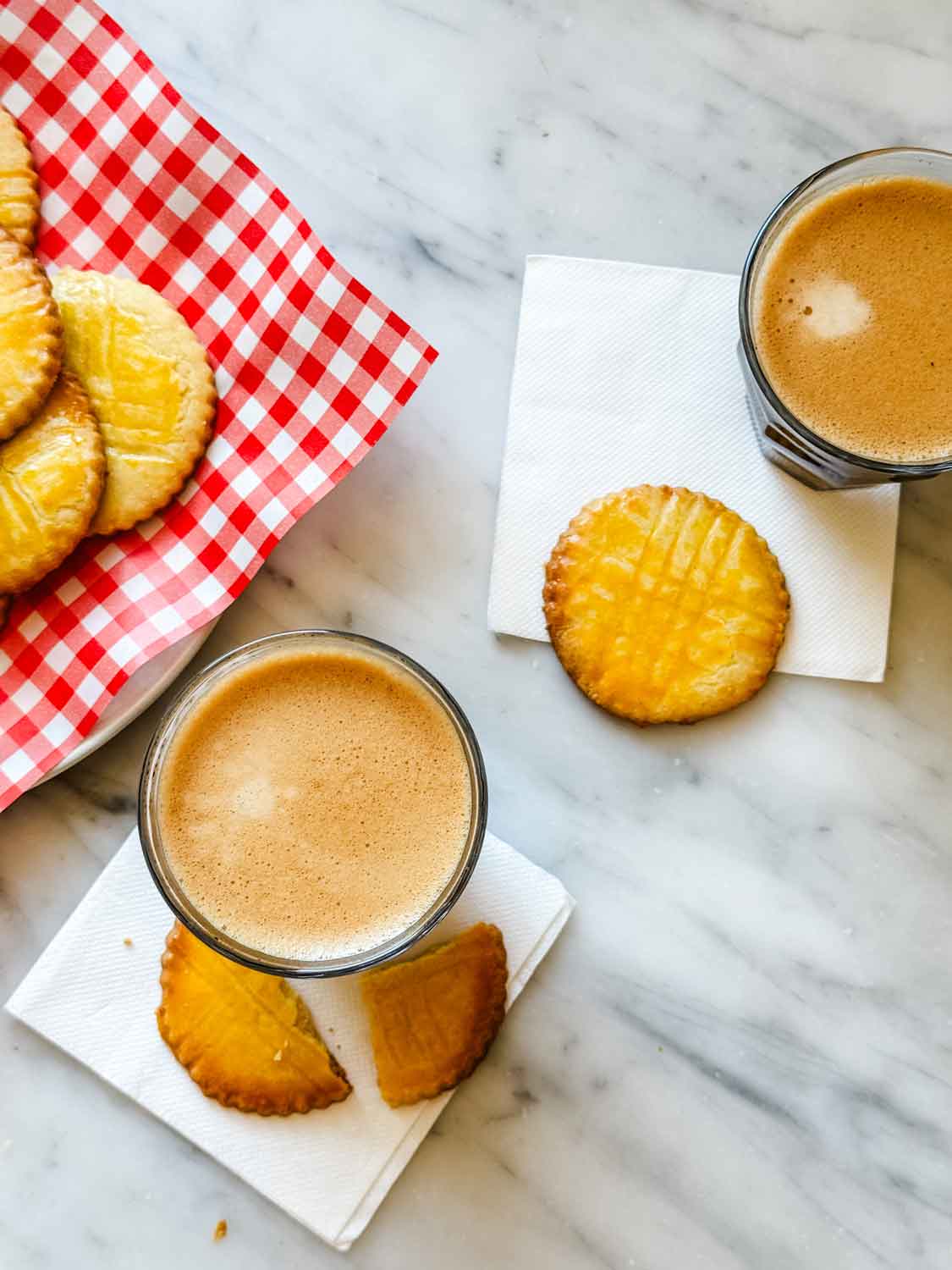 Sablés Breton French butter cookies are served with two cups of espresso.