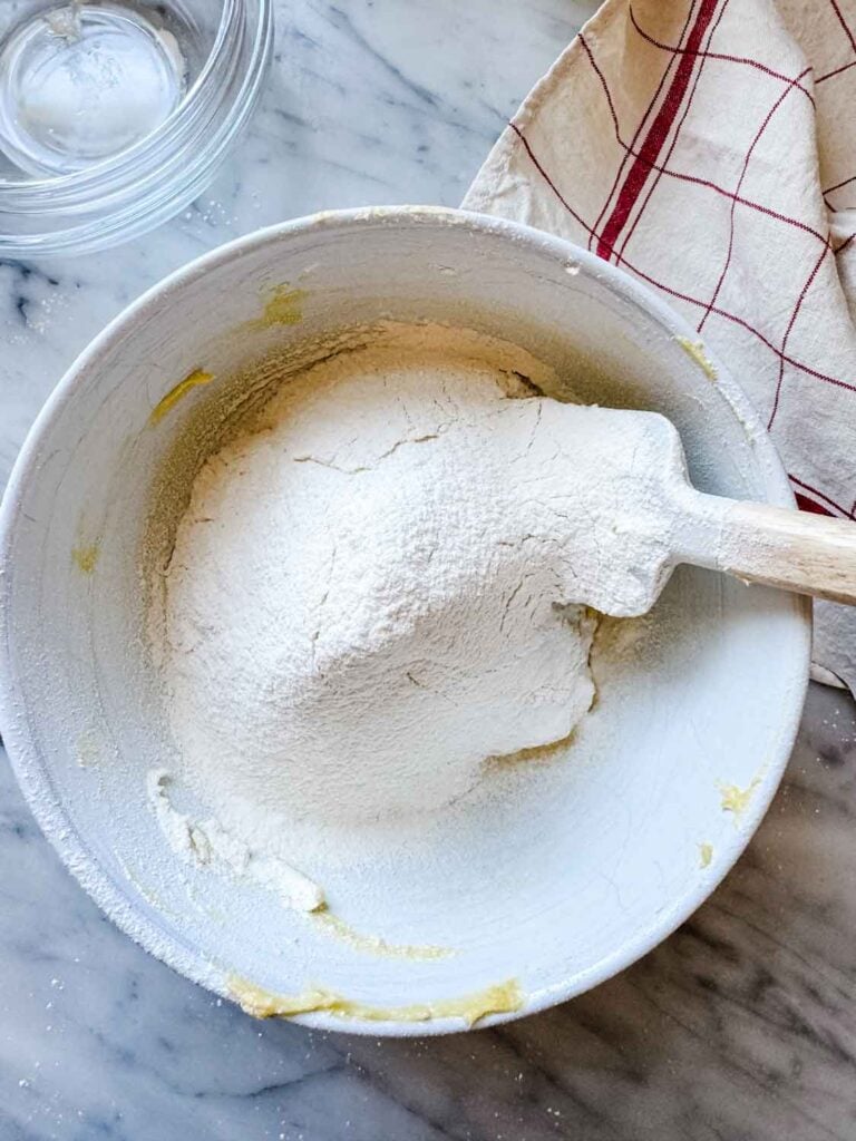 Flour and baking powder are added to the wet ingredients for this cookie recipe.