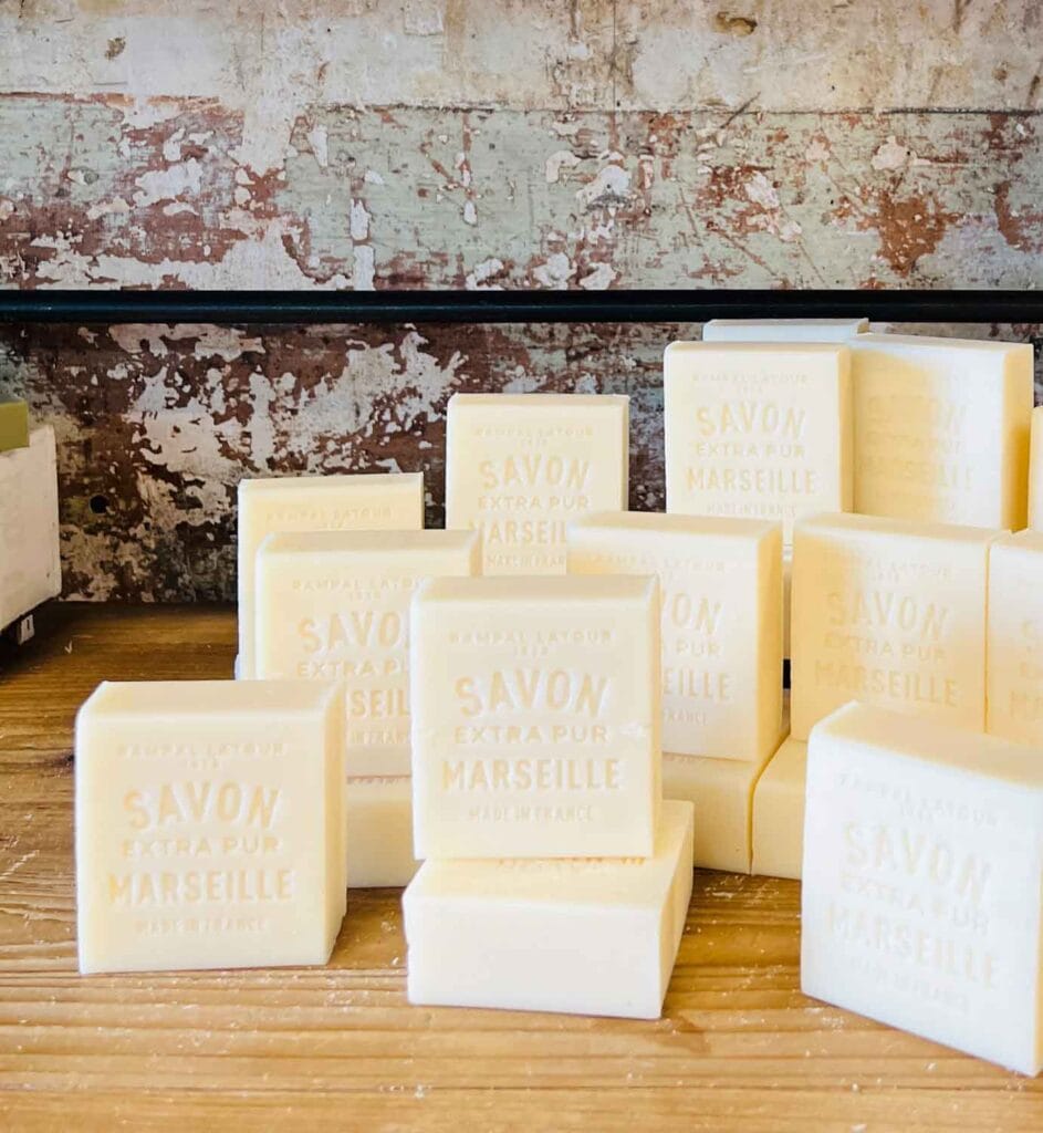 White bars of Savon Marseille soap are on this table.