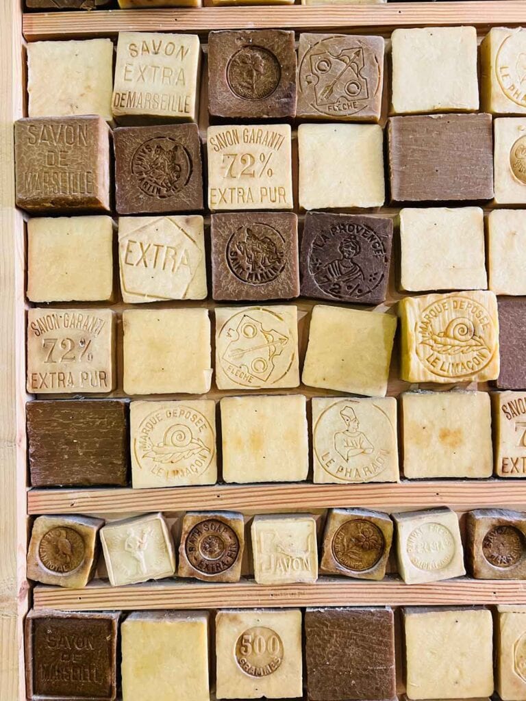 Different colors of blocks of soap are on a wooden wall rack inside the Rampal Latour flagship store.