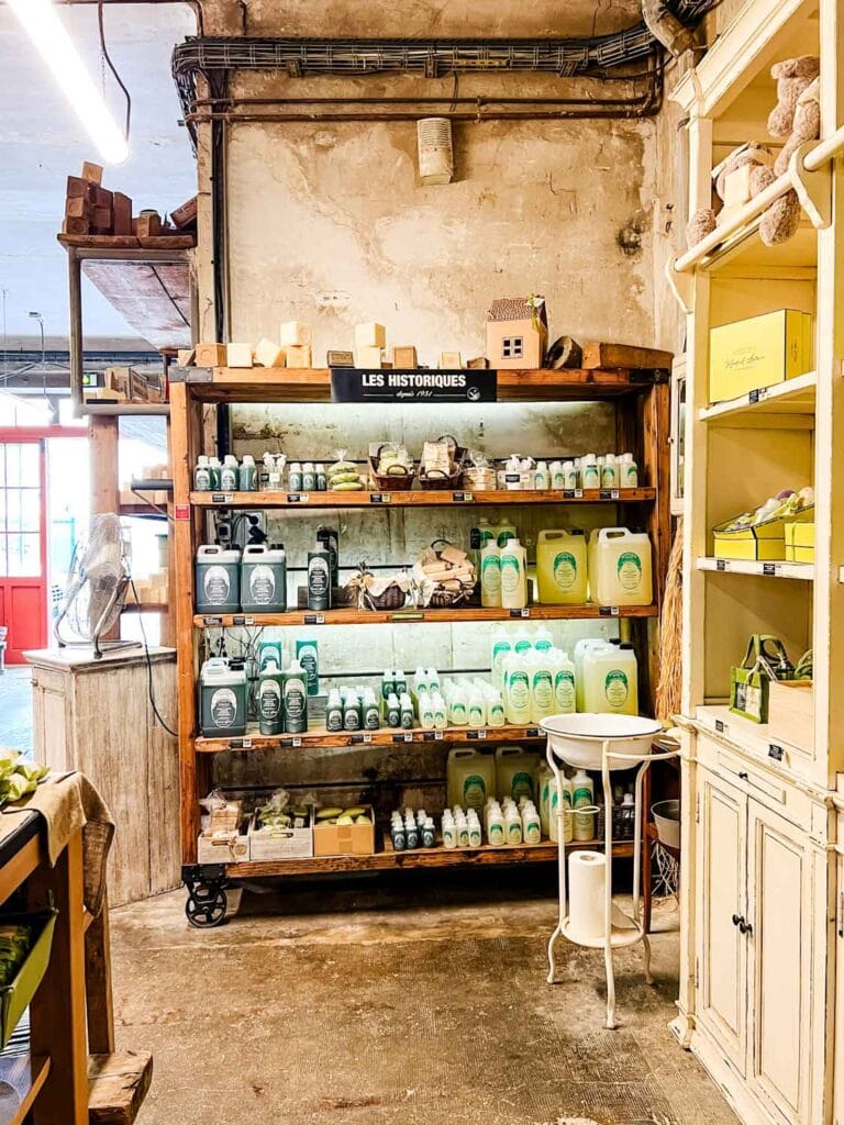 A large wooden shelf holds some of Rampal Latours' new products that are for sale.