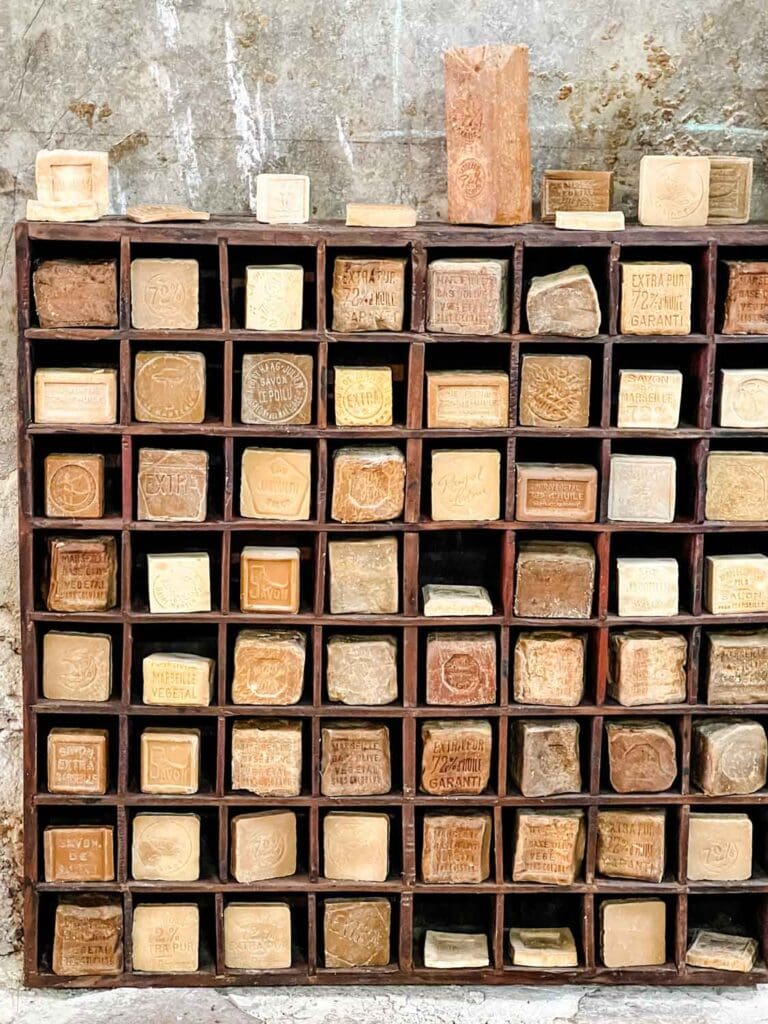 Stacks of cubes of soap are in wooden crates on one wall inside the Rampal Latour soap factory museum.