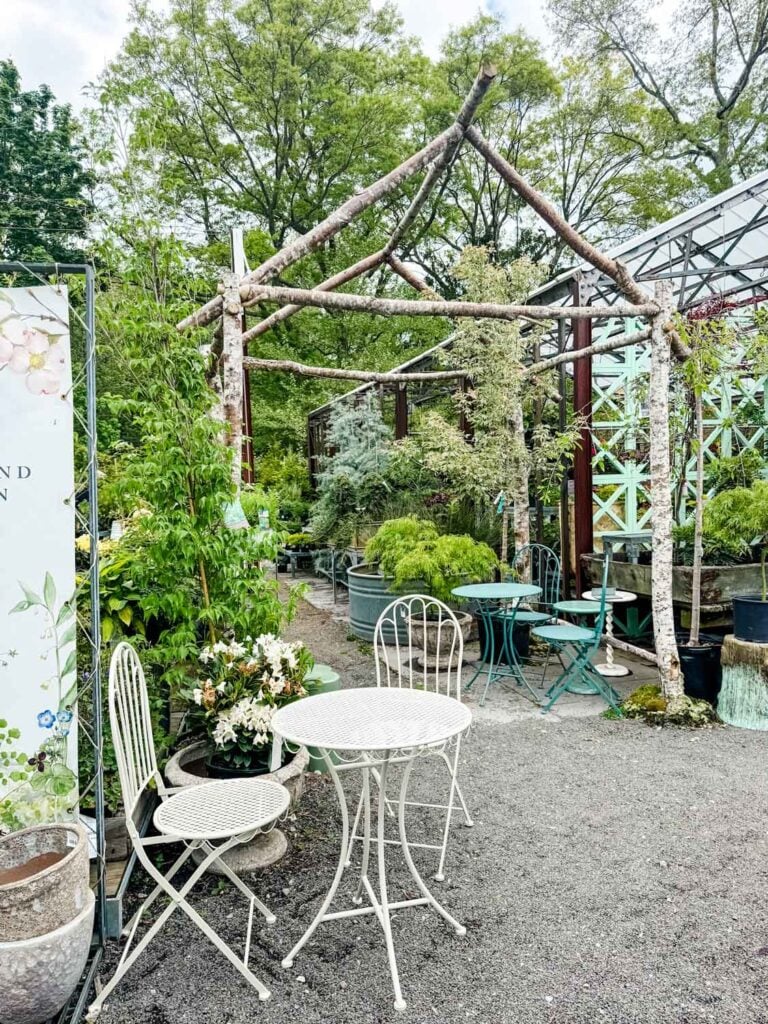 White garden table set and green garden set at Terrain.