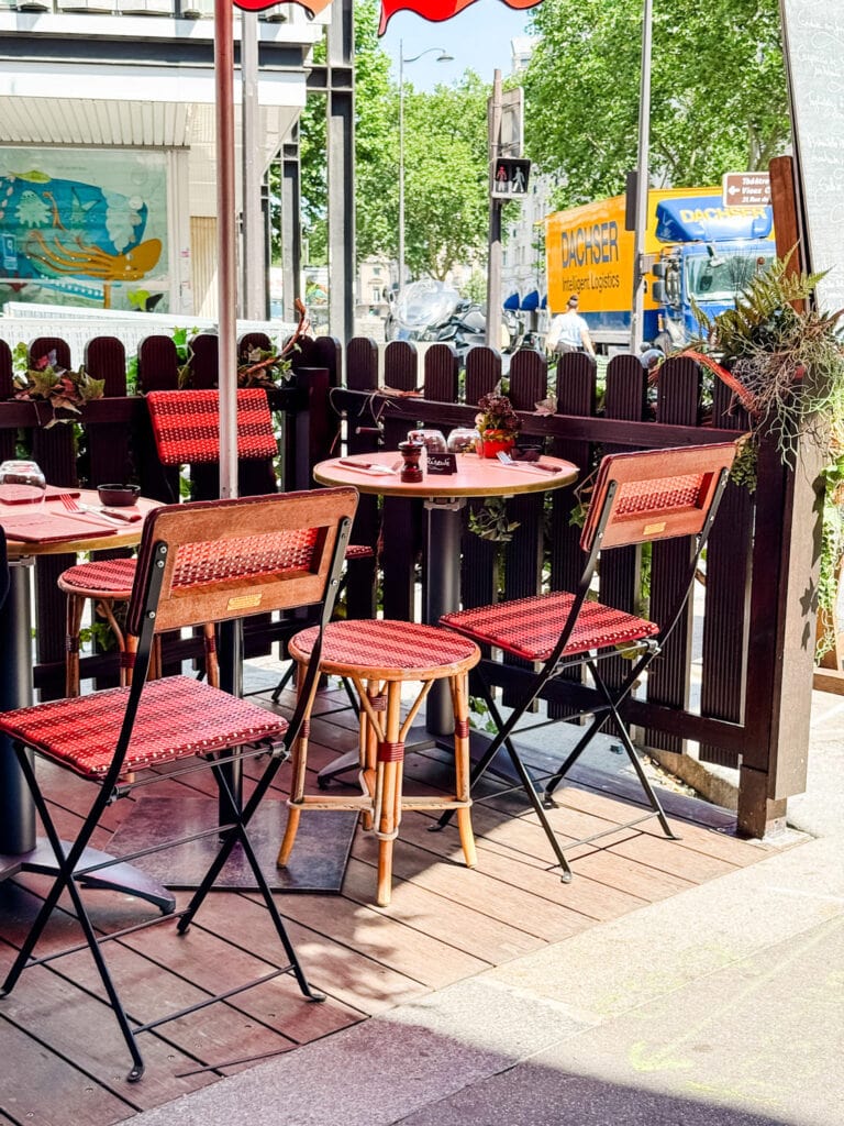 Tables and chair in front of Le Raspail bistro in Paris.