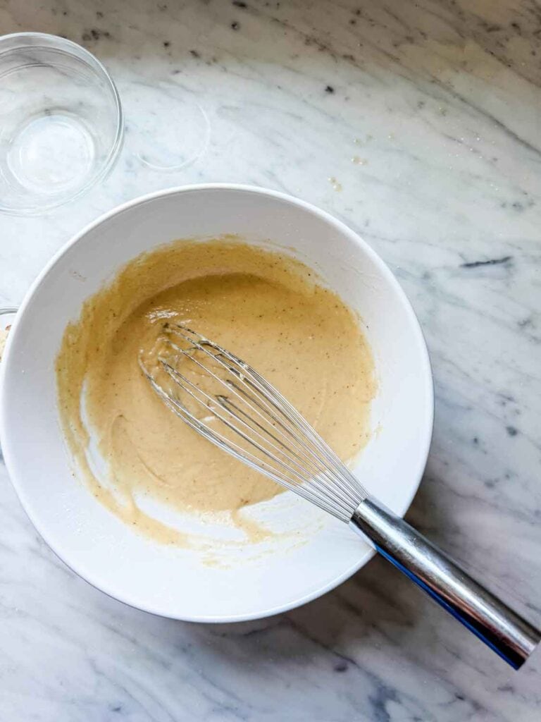 Classic French financier batter is ready to be poured into mini muffin tins.