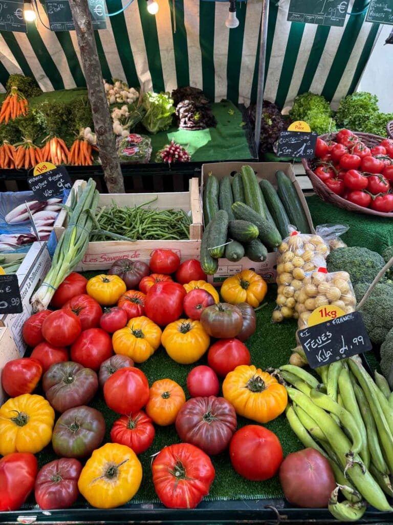 Scallions, heirloom tomatoes, beans, cucumbers, and potatoes can be found at Marché Raspail, one of Paris's many open-air markets.