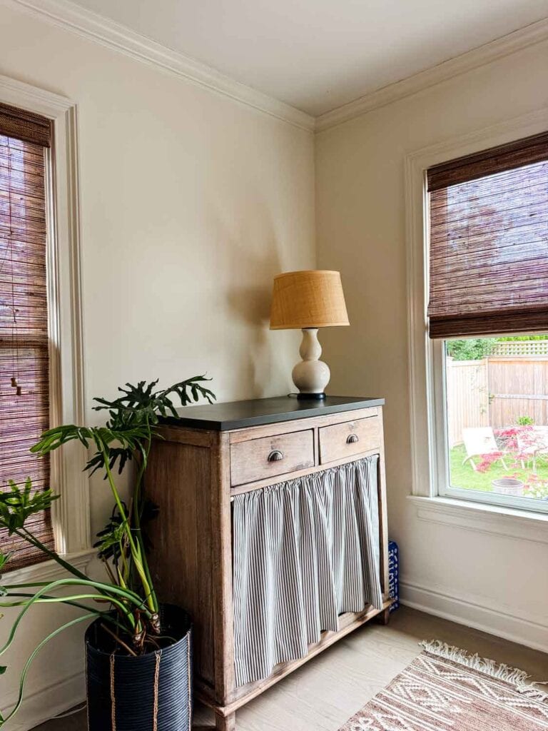 Vintage hutch with lamp, cafe curtain.