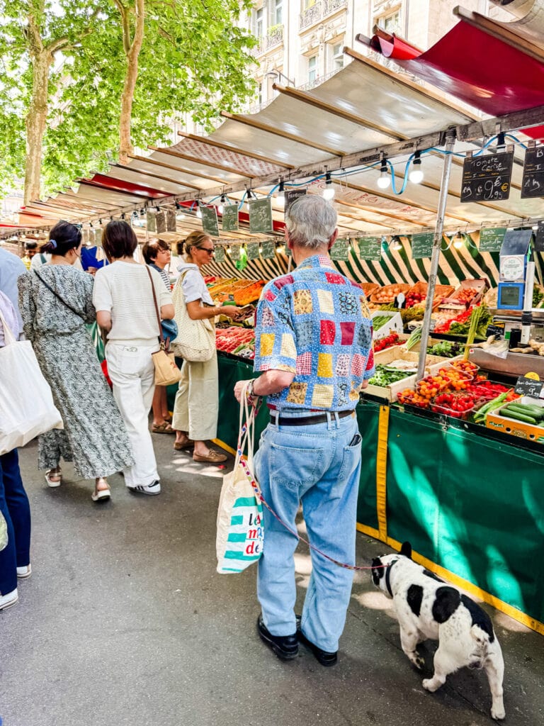 Local shoppers with cloth bags are buying their produce locally at Marché Raspail in Paris.