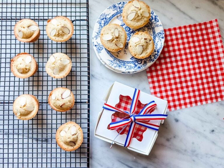 Classic French financier tea cakes are packaged in a lovely white box with red, white, and blue ribbon.