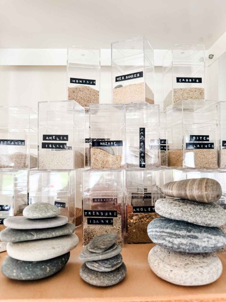 Sand collection with DYMO labels in acrylic boxes, stones.