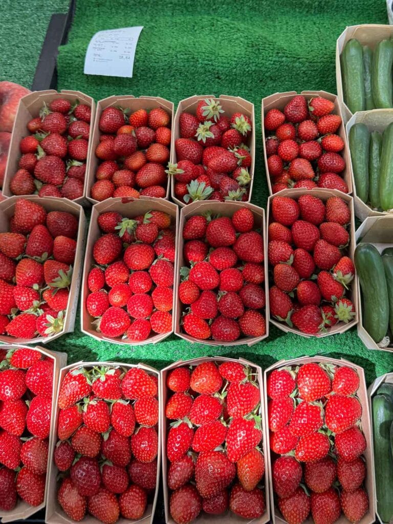 Fresh, deep red strawberries are for sale on a table at Marché Raspail, one of Paris's largest open-air markets.
