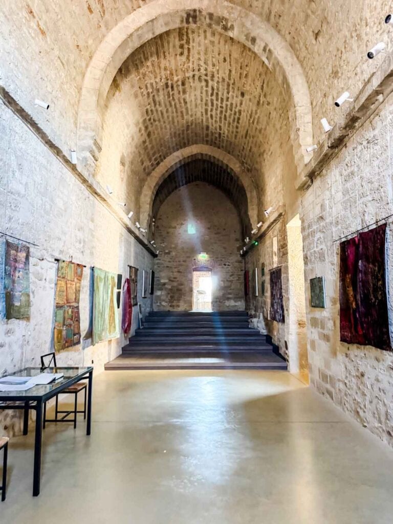 A massive hallway lined with photos on the walls, in the wine and truffle museum.