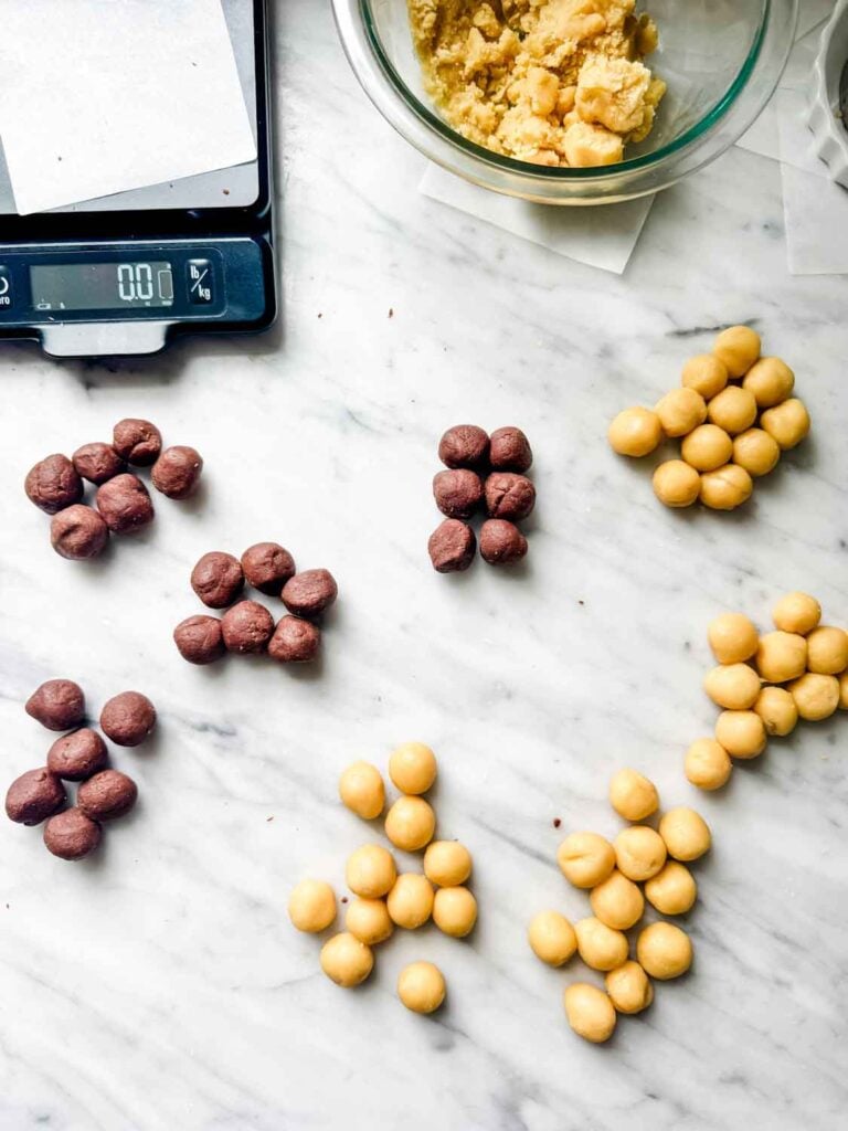Vanilla and chocolate cookie dough, small dough balls, kitchen scale.