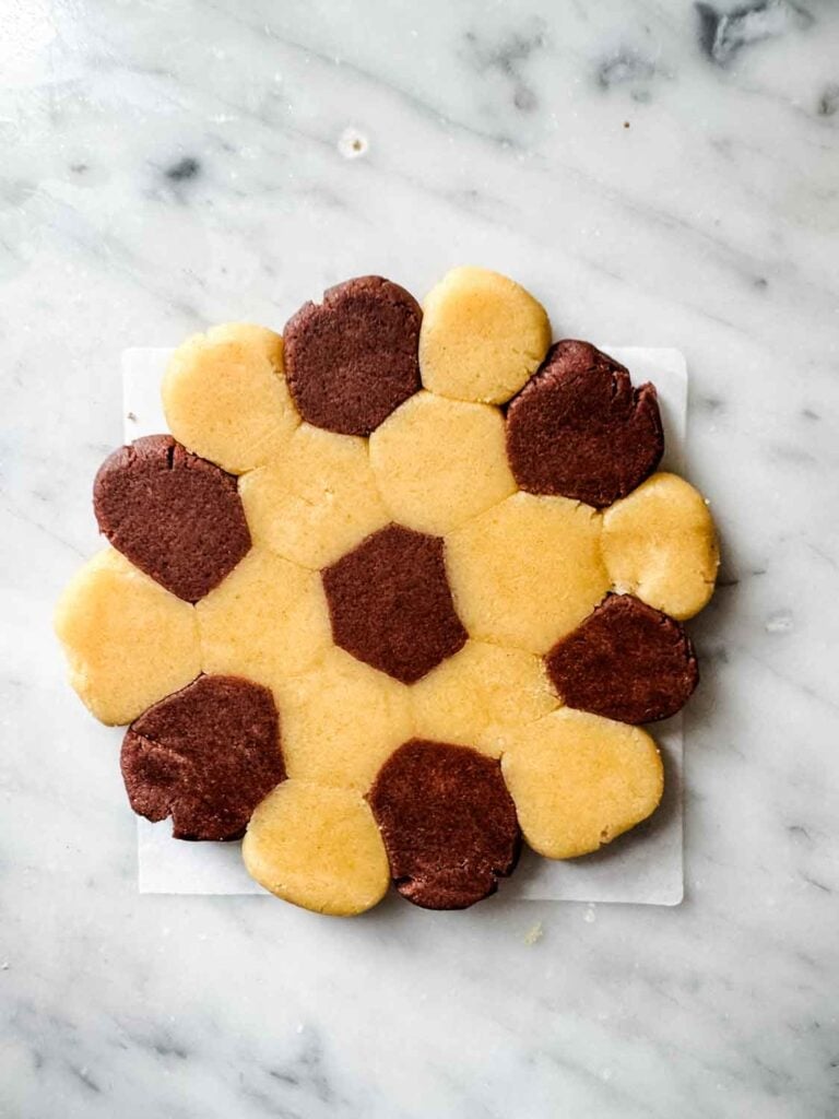 Vanilla and chocolate cookie dough, small dough balls, flattened.