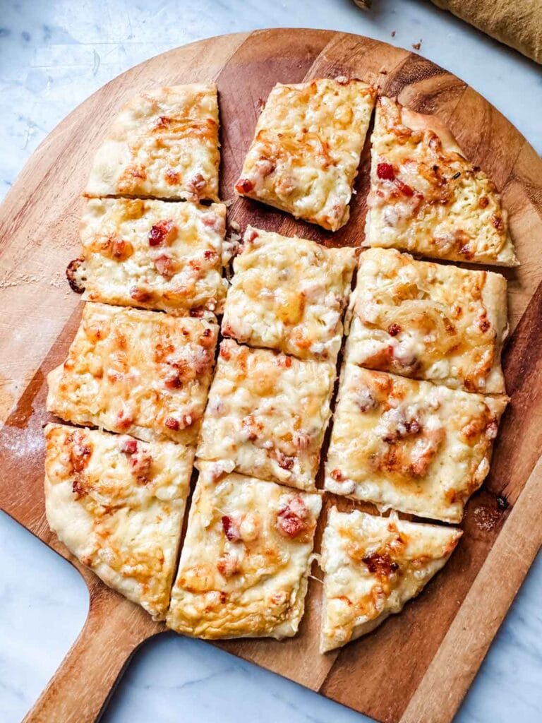 Pizza on peel cut into squares.