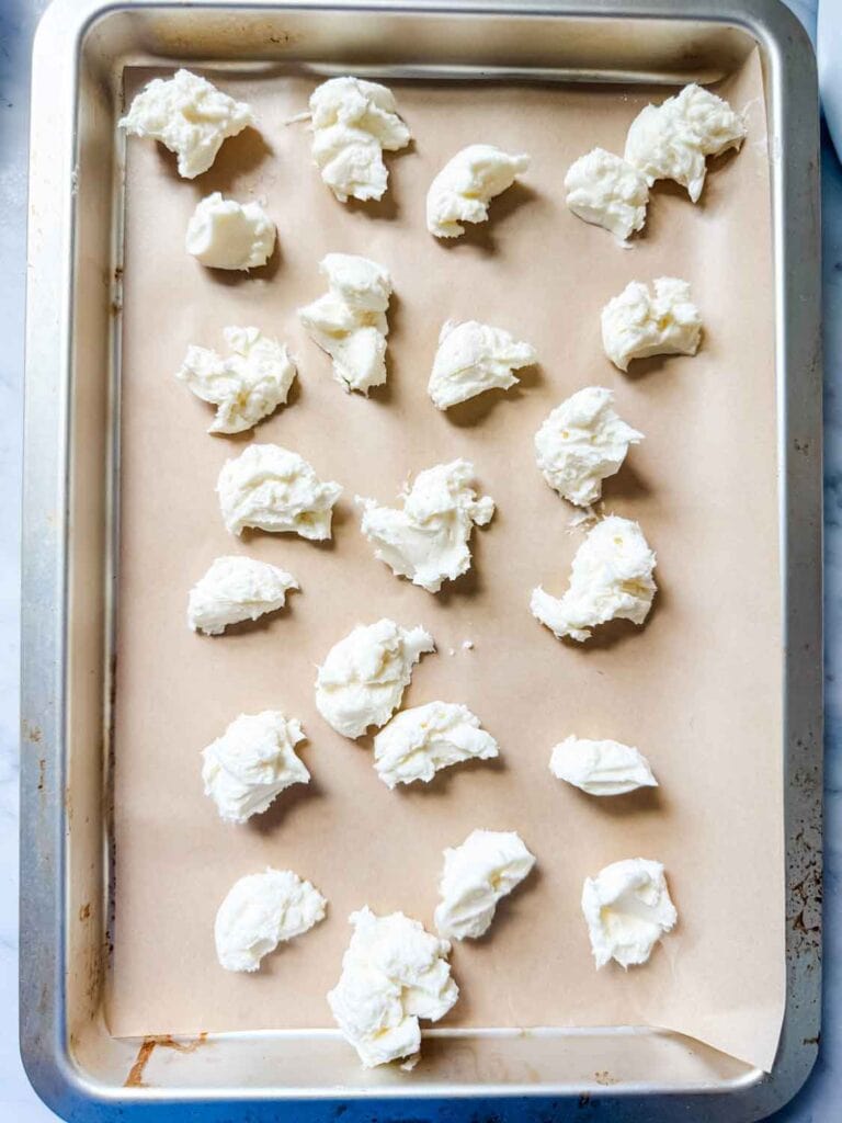 Filling on parchment paper lined baking sheet to make Strawberry cheesecake cookies.