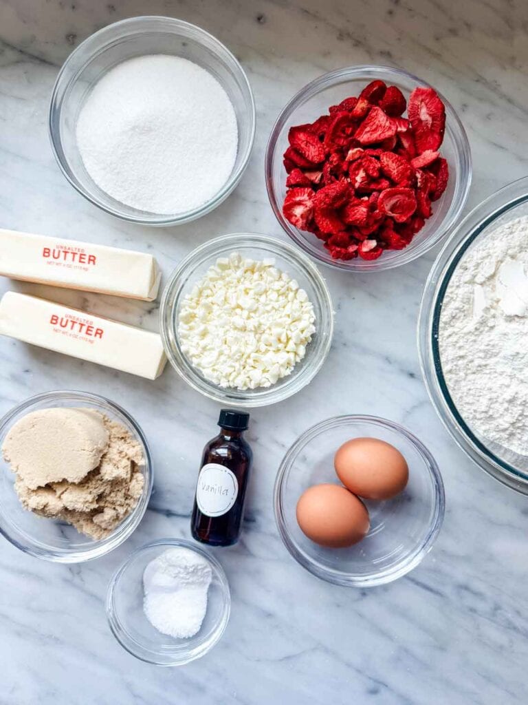 Igredients to make Strawberry cheesecake cookies in small glass bowls.