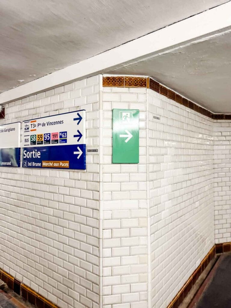 Exit signs in the Paris metro system point you to the Portes Vanves Flea Market in Paris.