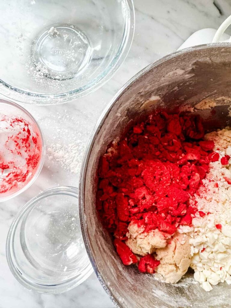 Mixing bowls empty, plus larger bowl with cookie dough and freeze dried strawberries.