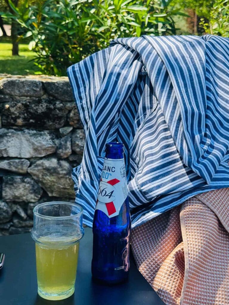 Stripe shirt, 1664 beer, and glass.