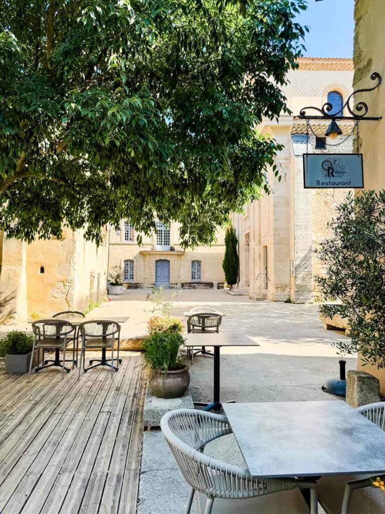 A few empty tables and chairs just a few steps away from the wine and truffle museum in Richerenches, France.