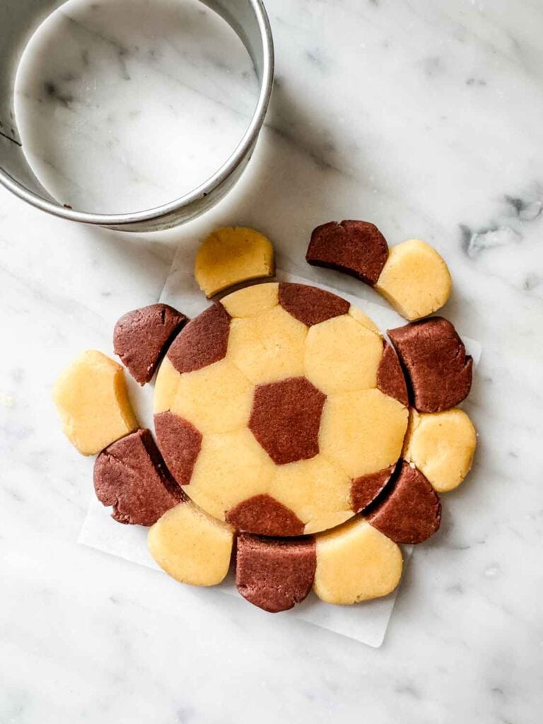Vanilla and chocolate cookie dough, small dough balls, flattened, then cut to look like a soccer ball.