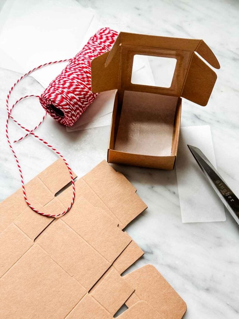 Tiny kraft paper box, flat boxes, bakers' twine and parchemnt paper. 