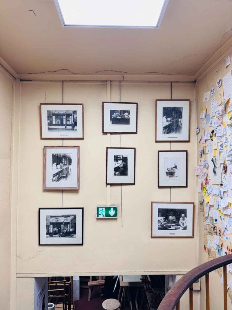 Vintage photographs on the stairwell wall at famous art supply store in Paris. 